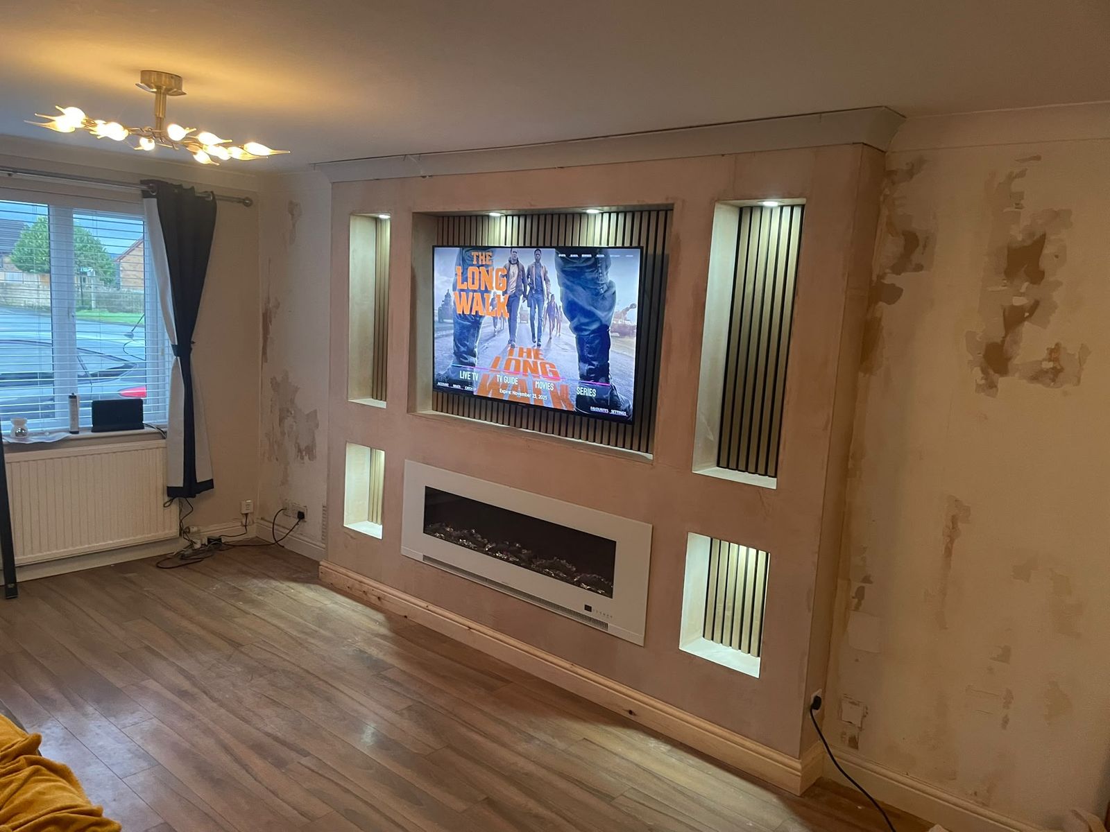 Finished media wall with fire and display niches