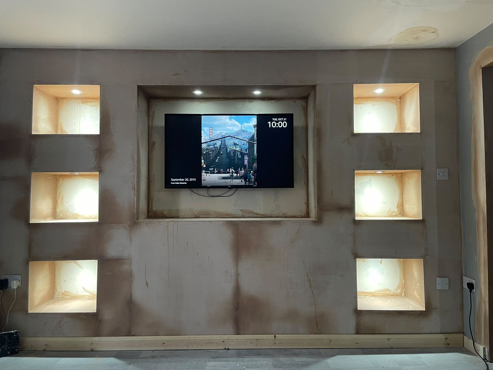 Media wall freshly plastered with lit niches